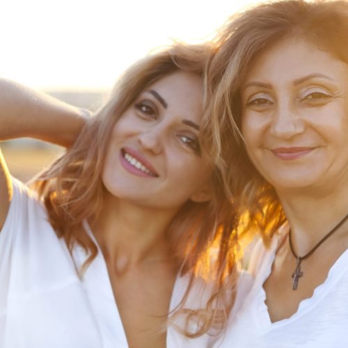 Two happy women in the lavander field. Middle age woman with her adult daughter in sunset light